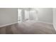 A cozy carpeted bedroom features neutral walls and a view of the en-suite bathroom and hallway at 3533 Koyla Lndg # 5, Chamblee, GA 30341