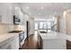 Stylish kitchen featuring white cabinets, island with sink, stainless appliances, and wood floors at 3533 Koyla Lndg # 5, Chamblee, GA 30341