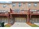 Rear exterior of townhomes with multiple wooden decks and access to the garages and driveways at 3533 Koyla Lndg # 5, Chamblee, GA 30341
