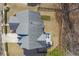 An aerial view shows the layout of this home, with a deck and a large roof in a wooded neighborhood at 4815 Westgate Dr, Cumming, GA 30040