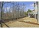 A spacious backyard with a fence and a deck overlooking the wooded area provides a private outdoor space at 4815 Westgate Dr, Cumming, GA 30040