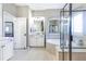 Bright bathroom featuring a soaking tub, a separate shower, and dual vanities at 4815 Westgate Dr, Cumming, GA 30040