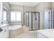 Elegant bathroom featuring a soaking tub, a separate shower, and lots of natural light at 4815 Westgate Dr, Cumming, GA 30040