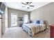 Bedroom boasts a ceiling fan, a walk-out balcony, and a carpeted floor at 4815 Westgate Dr, Cumming, GA 30040