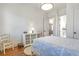 Bright bedroom featuring hardwood floors, white furniture, and an ensuite bathroom at 4815 Westgate Dr, Cumming, GA 30040