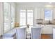 Bright breakfast nook with built-in seating surrounded by windows with bright natural light at 4815 Westgate Dr, Cumming, GA 30040