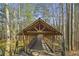 Picturesque covered bridge leading to a pond, surrounded by lush trees, creating a serene outdoor escape at 4815 Westgate Dr, Cumming, GA 30040