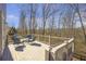 Outdoor deck with views of a wooded backyard, patio furniture, and space for grilling at 4815 Westgate Dr, Cumming, GA 30040