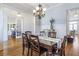 Spacious dining room with hardwood floors, chandelier, and views of the adjacent living spaces at 4815 Westgate Dr, Cumming, GA 30040
