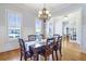 Dining room featuring hardwood floors, large windows, and a view into the home office at 4815 Westgate Dr, Cumming, GA 30040