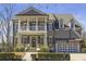 Charming two-story home featuring a welcoming front porch, stone accents, and manicured landscaping at 4815 Westgate Dr, Cumming, GA 30040