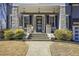 Close-up of the inviting front porch with stone columns, pendant lights, and a welcoming entrance at 4815 Westgate Dr, Cumming, GA 30040