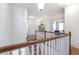 Upstairs hallway featuring hardwood floors, decorative railing and arched display nook at 4815 Westgate Dr, Cumming, GA 30040