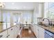 Spacious kitchen featuring an island, granite counters, stainless appliances, and breakfast nook by large windows at 4815 Westgate Dr, Cumming, GA 30040