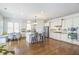 Bright kitchen featuring an island, stainless steel appliances, wooden floors, and an eat-in breakfast area at 4815 Westgate Dr, Cumming, GA 30040