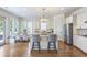 Bright kitchen featuring an island, stainless steel appliances, wooden floors, and an eat-in breakfast area at 4815 Westgate Dr, Cumming, GA 30040