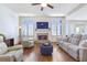 Cozy living room with a stone fireplace, hardwood floors, and comfortable seating at 4815 Westgate Dr, Cumming, GA 30040