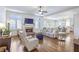 Bright and open living room with a fireplace, hardwood floors, and access to the kitchen at 4815 Westgate Dr, Cumming, GA 30040