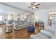 Inviting living room featuring hardwood floors, a ceiling fan, and an open floor plan flowing into the kitchen at 4815 Westgate Dr, Cumming, GA 30040
