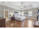 Spacious bedroom with hardwood floors, a ceiling fan, and windows providing natural light at 4815 Westgate Dr, Cumming, GA 30040