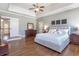 Spacious bedroom with hardwood floors, a ceiling fan, and windows providing natural light at 4815 Westgate Dr, Cumming, GA 30040