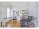 Home office with built-in bookshelves, hardwood floors, and ample natural light at 4815 Westgate Dr, Cumming, GA 30040