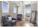 Cozy room with hardwood floors, a comfy chair, and natural light from multiple windows at 4815 Westgate Dr, Cumming, GA 30040