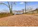 Large backyard with a privacy fence and mature trees at 1318 Beecher St, Atlanta, GA 30310