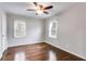 Bedroom with hardwood floors, ceiling fan, and natural light from two windows at 1318 Beecher St, Atlanta, GA 30310