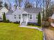 Charming home with a light grey brick facade, manicured lawn, and inviting front entrance steps at 1318 Beecher St, Atlanta, GA 30310