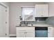 Modern kitchen featuring white cabinets, granite counters, stainless sink, and a subway tile backsplash at 1318 Beecher St, Atlanta, GA 30310