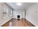 Spacious room featuring hardwood floors, white trim, a fireplace, and natural light at 1318 Beecher St, Atlanta, GA 30310