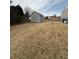 Large backyard featuring a utility shed for storage and ample room for outdoor activities at 1631 Royal Ives Dr, Lawrenceville, GA 30045