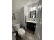 Compact bathroom with a vanity, mirror, and a clean toilet at 1631 Royal Ives Dr, Lawrenceville, GA 30045