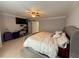 Spacious bedroom with a ceiling fan, TV, and comfortable bed at 1631 Royal Ives Dr, Lawrenceville, GA 30045