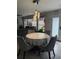 Charming dining area with a round table, elegant chandelier, and views from the windows at 1631 Royal Ives Dr, Lawrenceville, GA 30045