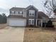 Charming two-story home featuring stone accents and a well-maintained front yard at 1631 Royal Ives Dr, Lawrenceville, GA 30045