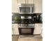 Modern kitchen with stainless steel appliances and black countertop at 1631 Royal Ives Dr, Lawrenceville, GA 30045
