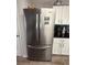 Stainless steel refrigerator complementing the white cabinets in this kitchen at 1631 Royal Ives Dr, Lawrenceville, GA 30045