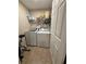 Laundry room featuring a white washer and dryer, with storage shelves at 1631 Royal Ives Dr, Lawrenceville, GA 30045