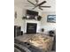Cozy living room featuring a fireplace, flat-screen TV, ceiling fan, and comfortable seating at 1631 Royal Ives Dr, Lawrenceville, GA 30045