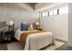 Comfortable bedroom featuring concrete walls, large window, and stylish decor for a relaxing retreat at 480 John Wesley Dobbs Ne Ave # 810, Atlanta, GA 30312