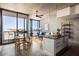Bright living room features concrete walls, a ceiling fan, and a balcony with city views at 480 John Wesley Dobbs Ne Ave # 810, Atlanta, GA 30312