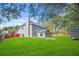 A home and chimney overlook a bright green backyard with a storage shed at 1021 Adah Ln, Lawrenceville, GA 30043