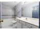 Bathroom featuring a tub with a gray-tiled shower and a white vanity at 1021 Adah Ln, Lawrenceville, GA 30043