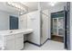 Bathroom showcasing a large mirror, vanity, and a walk-in shower, plus access to the walk-in closet at 1021 Adah Ln, Lawrenceville, GA 30043