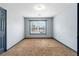 Bedroom featuring neutral walls, a single window, and a door for easy access at 1021 Adah Ln, Lawrenceville, GA 30043
