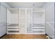 Walk-in closet featuring custom shelving and ample storage space for clothes and accessories at 1021 Adah Ln, Lawrenceville, GA 30043