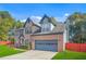 Beautiful two-story brick home with blue shutters, attached garage, and mature landscaping at 1021 Adah Ln, Lawrenceville, GA 30043