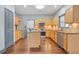 Well-lit kitchen featuring wood floors, granite countertops, an island, and stainless steel appliances at 1021 Adah Ln, Lawrenceville, GA 30043